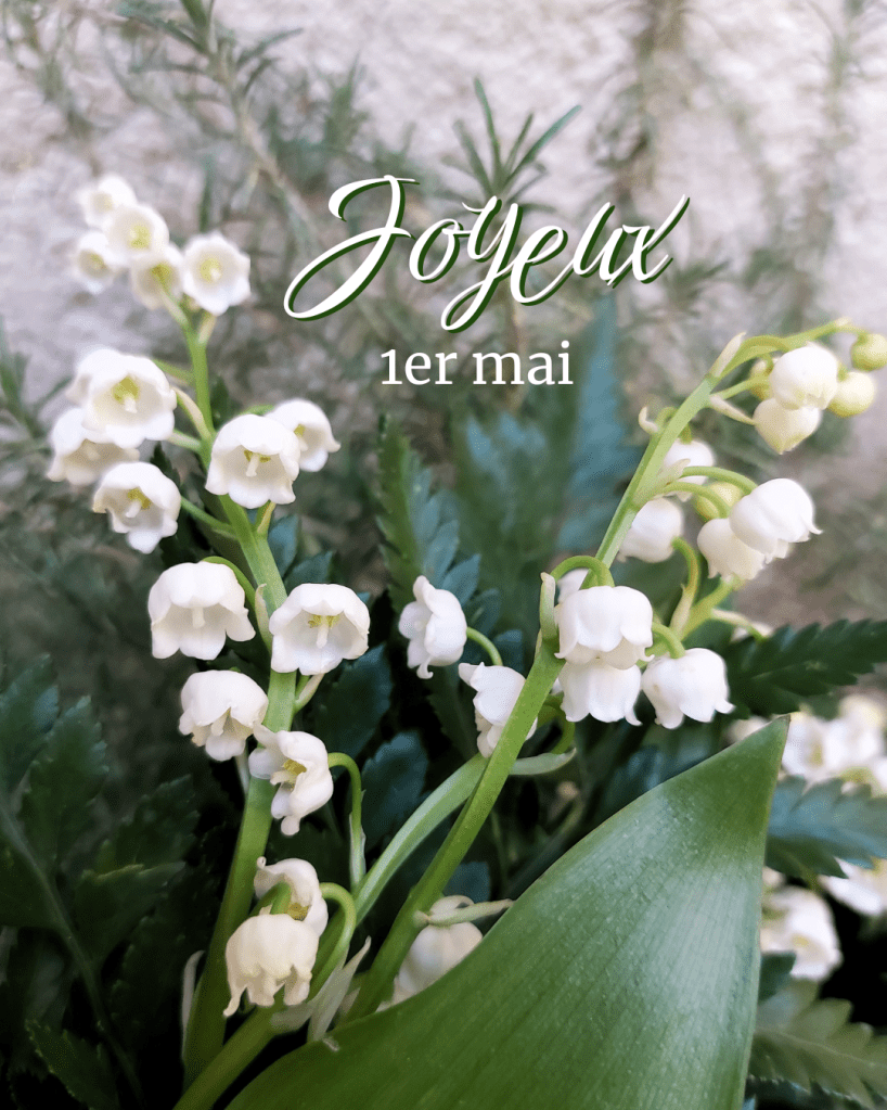 des brins de muguet avec le texte "Joyeux 1er mai"